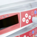 A medical device user presses a button