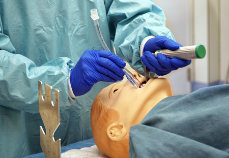 A usability participant entering a tube in a simulated patient